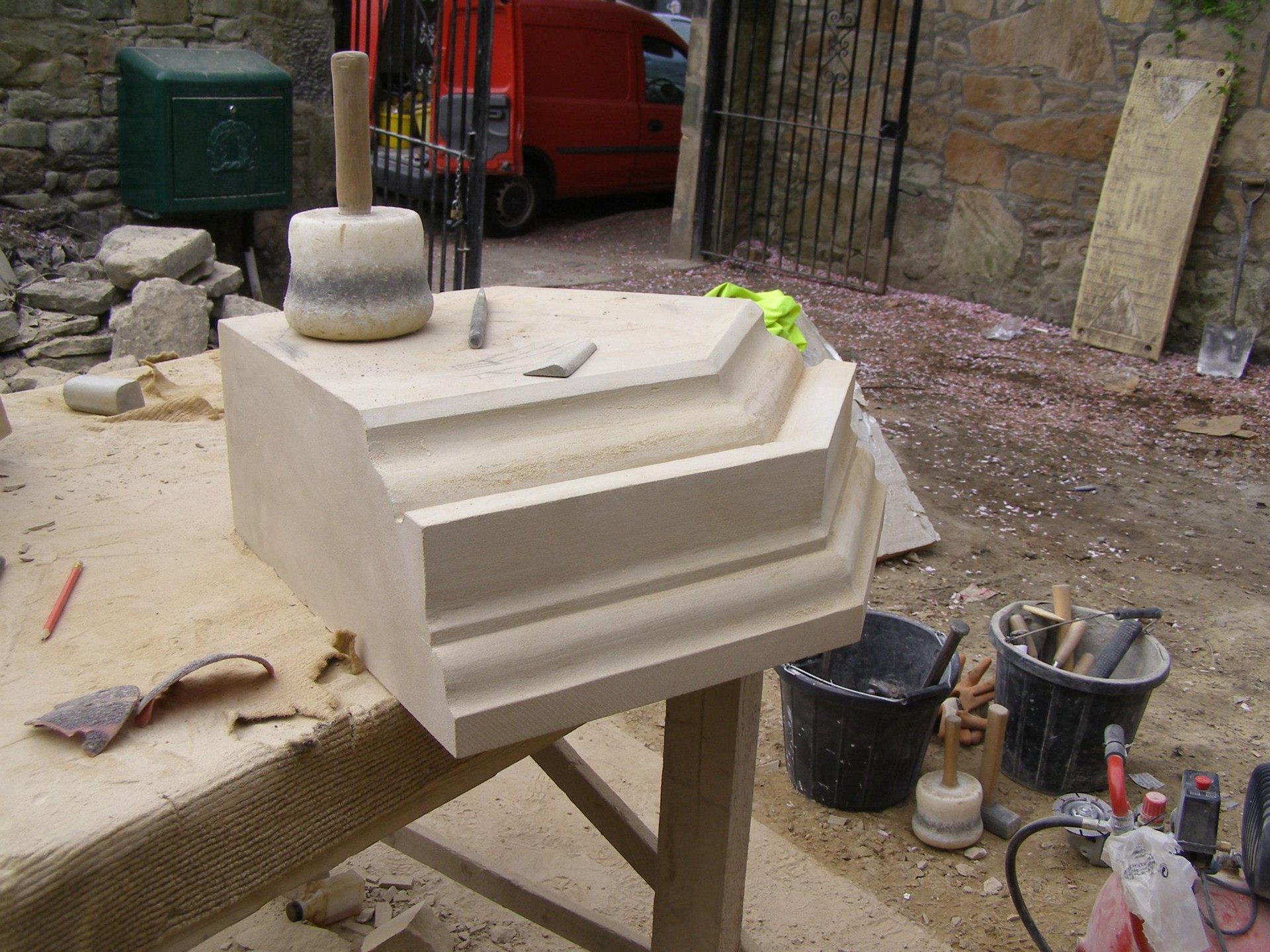 Handcrafted limestone step being shaped by Edinburgh stonemasons at MC Stonemasons Limited.