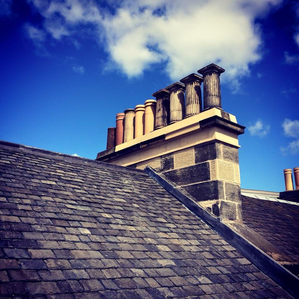 Old stone chimney with chimney pots, traditional Edinburgh stonemasonry.