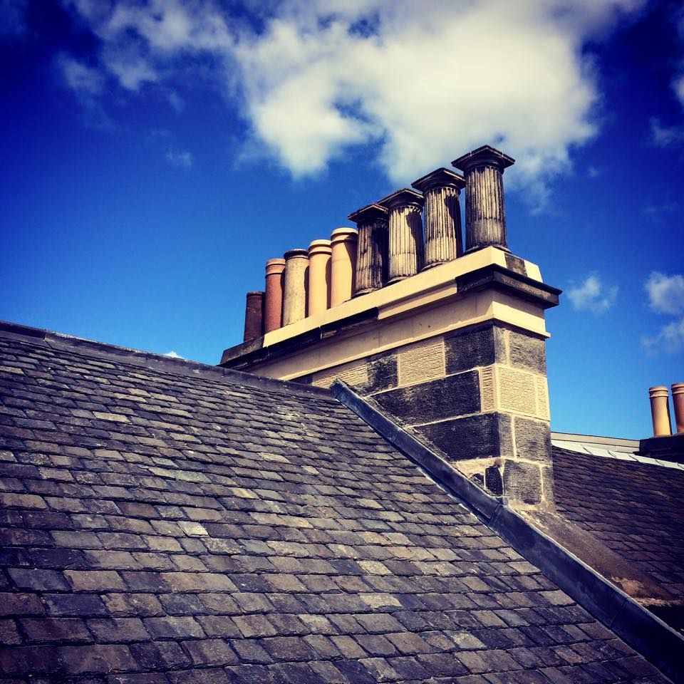 Old stone chimney with chimney pots, traditional Edinburgh stonemasonry.