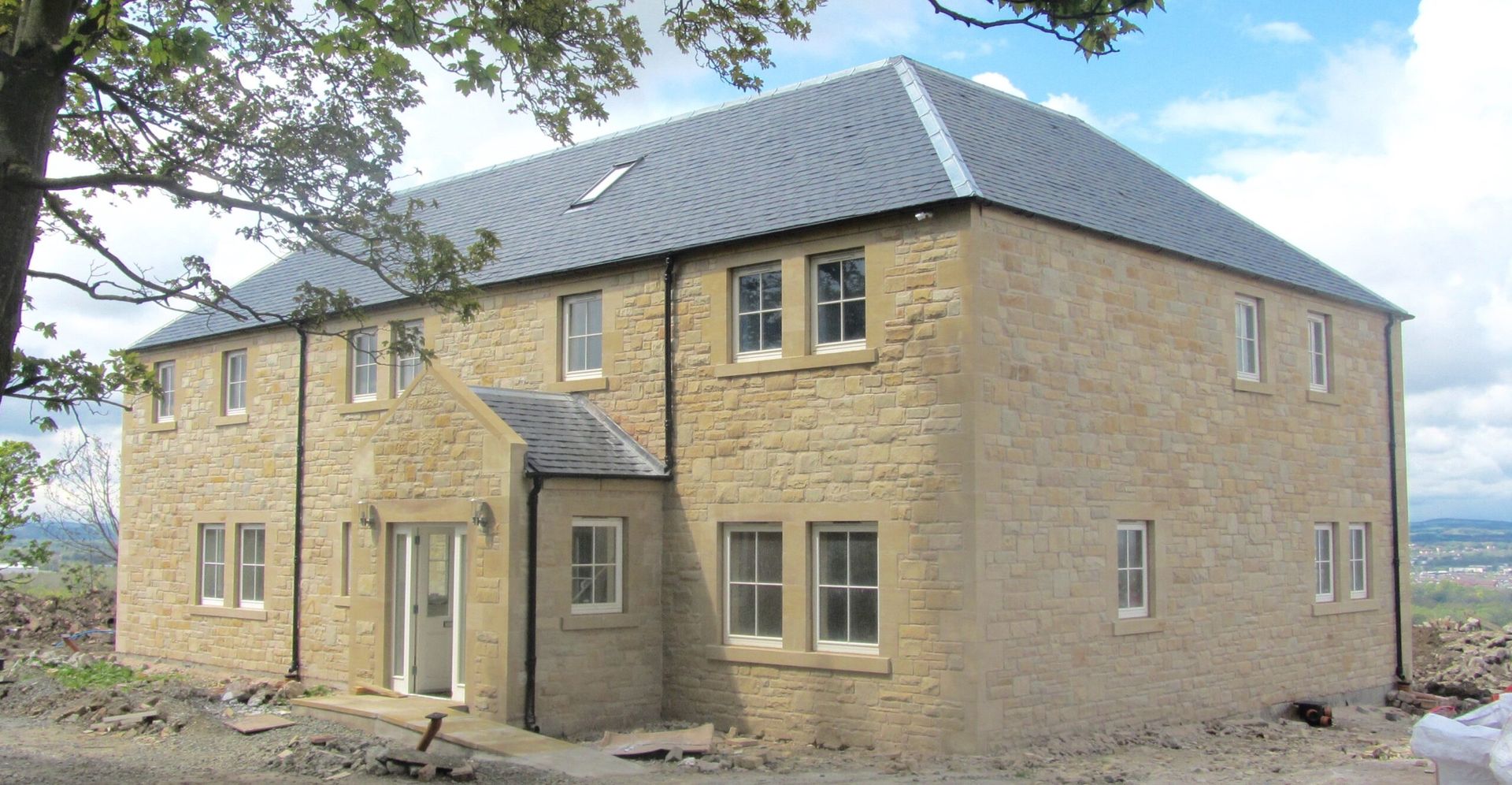 Natural stone house with traditional masonry, in Edinburgh. Expert stone masonry and stonemasonry services by IMC Stonemasons Limited.