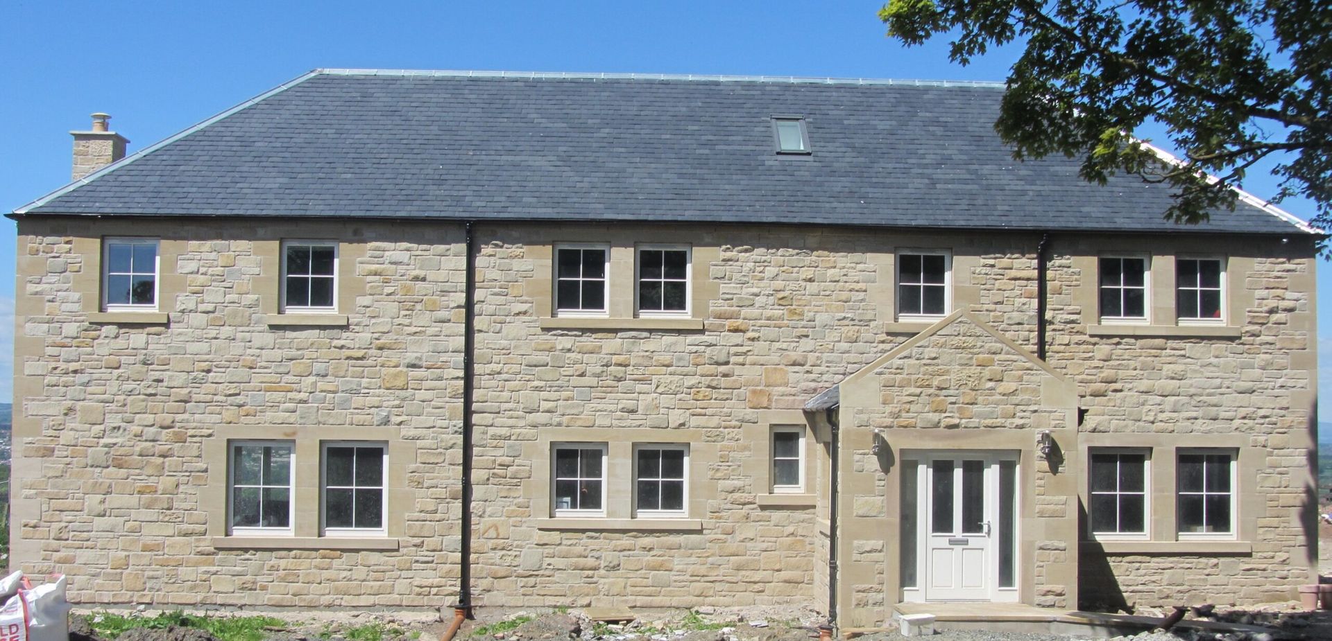 Traditional Edinburgh sandstone masonry renovation in progress. Skilled stonemasons at IMC Stonemasons Limited.