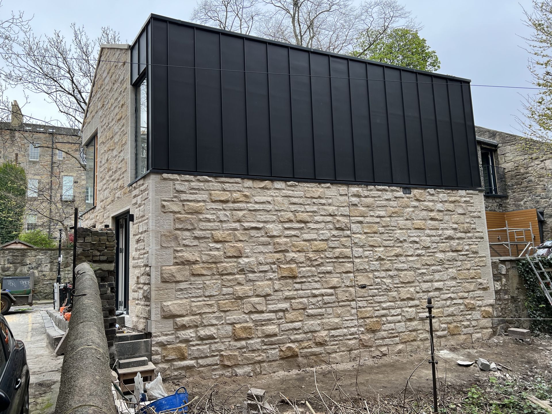 Traditional stone masonry with modern cladding for Edinburgh stone building renovation.