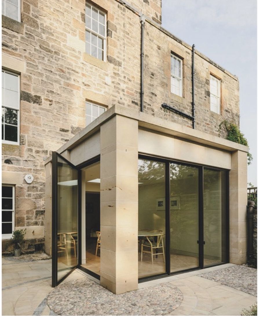 Elegant stone extension with large glass doors at historic Edinburgh building, crafted by IMC Stonemasons Ltd.