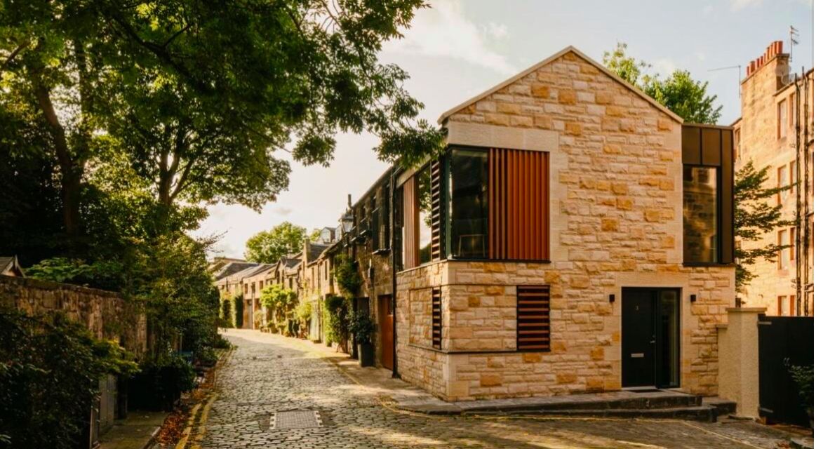 Contemporary stone-built house with modern design elements on a charming cobbled street in Edinburgh.