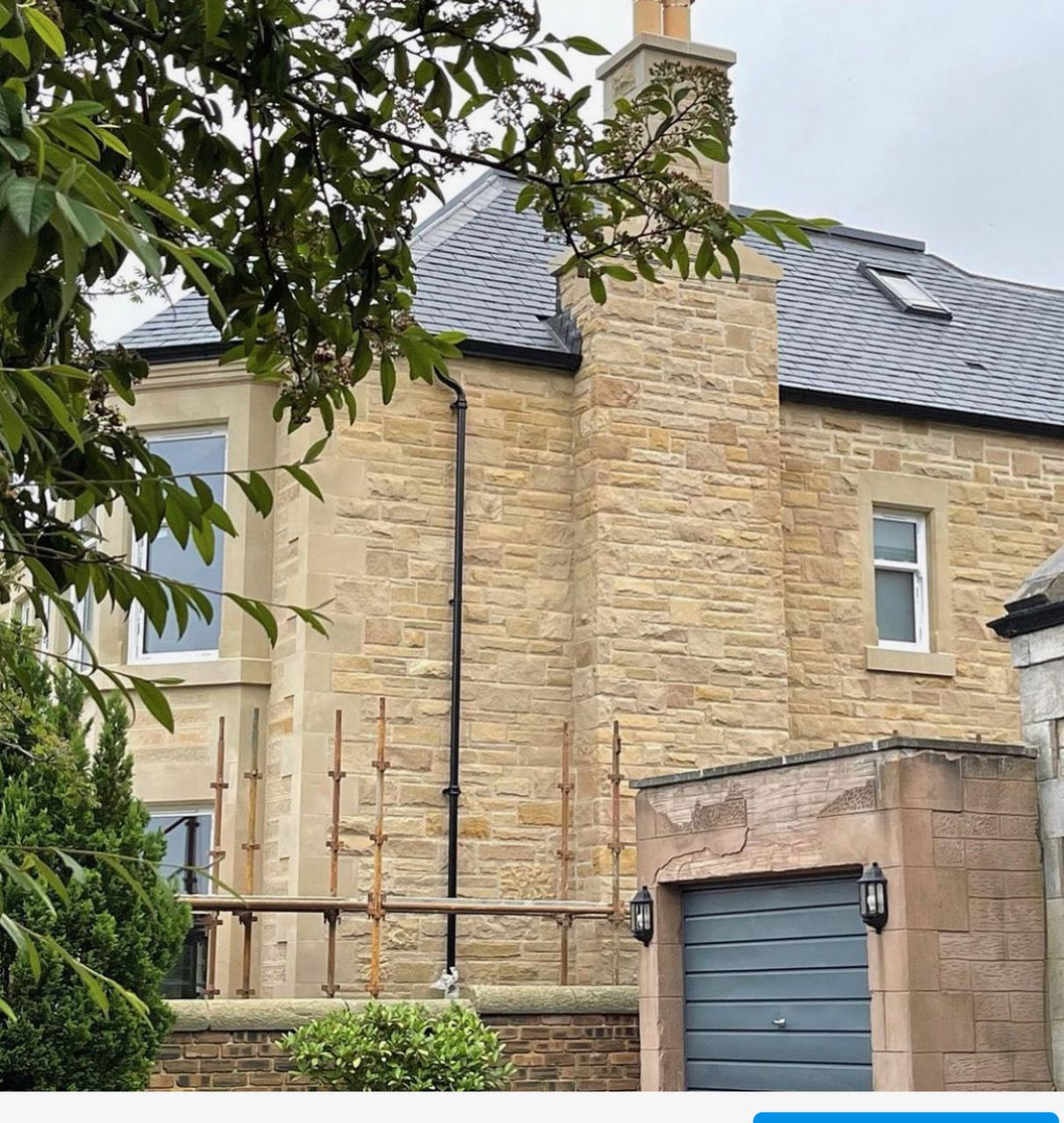 Weathered sandstone masonry exterior of a luxury residential home in Edinburgh, Scotland.